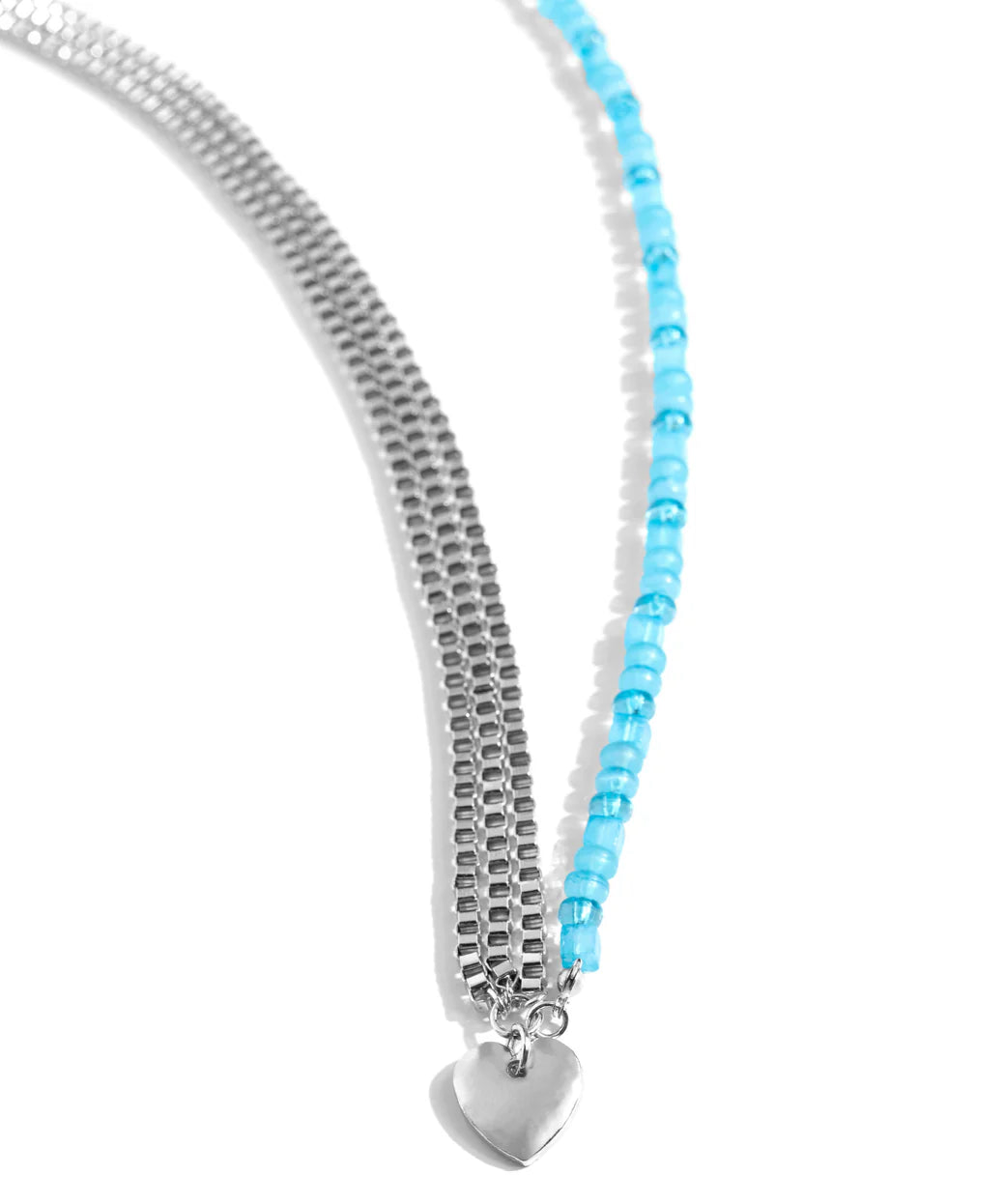 Infused along an invisible string, a collection of Capri Blue beads in varying shapes and opacities joins a trio of silver box chains connecting to a solitaire silver heart charm for a sweet summery statement. Features an adjustable clasp closure.
N3880
