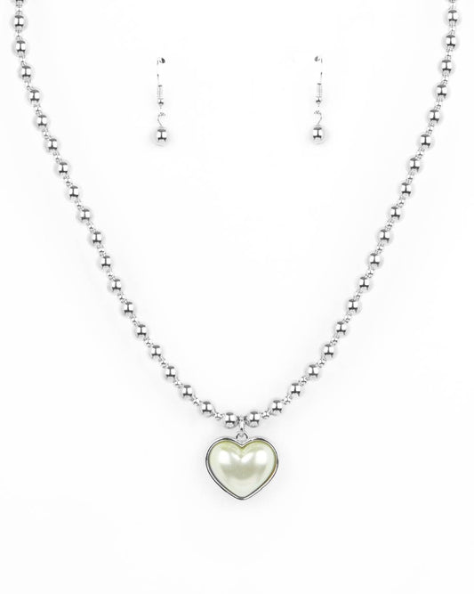 N1667
Featuring a pearly Green Ash center, a charming heart pendant glides along a strand of silver beads below the collar for a romantic flair. Features an adjustable clasp closure.